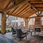 Courtyard at Waltonwood Lead Mine assisted living and memory care community, with a covered seating area, residential-style furnishings, and an outdoor fireplace.