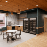 Interior architectural rendering of the centrally located Pelican Valley Senior Living café. The bright, welcoming social space features a kitchenette with light wood cabinetry, a hexagonal tile backsplash, and modern beverage stations. Small round dining tables and black spindle-back chairs sit beneath bronze pendant lights, framed by warm wood pillars and a deep green accent wall.